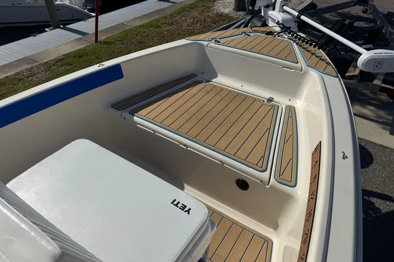 Slide: The Image of 2005 Scout 175 Sportfish boat interior with teak flooring and seating. - 3