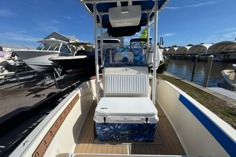 Slide: The Image of 2005 Scout 175 Sportfish boat interior with Yeti cooler, docked at marina under clear sky. - 4