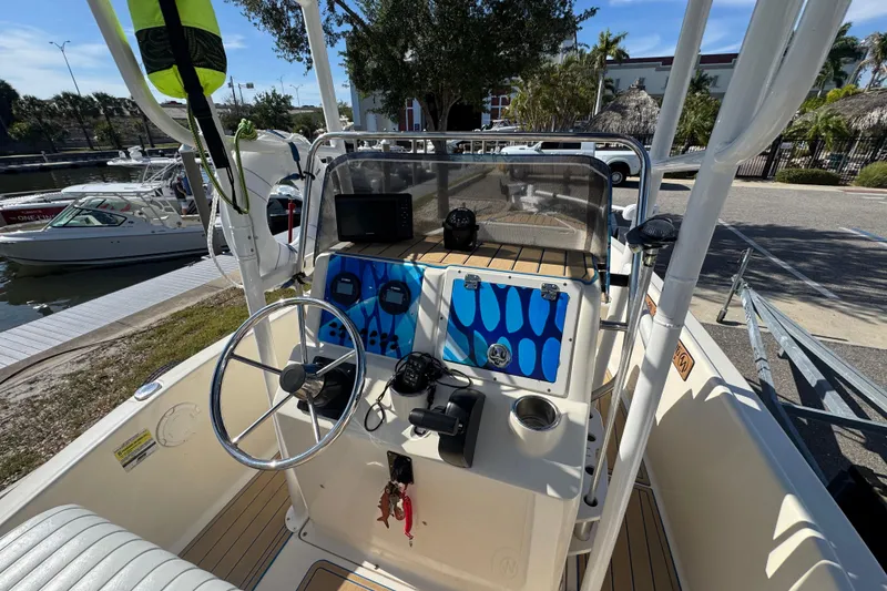Slide: The Image of 2005 Scout 175 Sportfish boat dashboard with steering wheel and navigation equipment. - 8