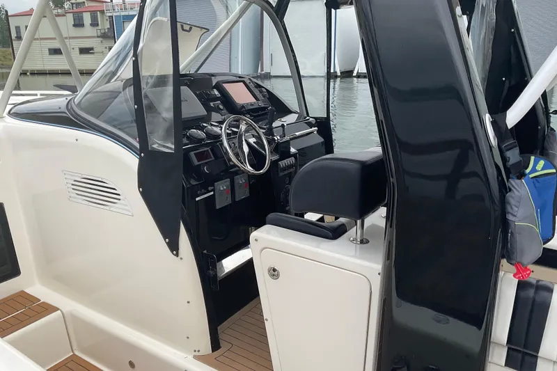 Slide: The Image of 2004 Rivolta PT Runner 4.0 boat cockpit with steering wheel and control panel. - 10