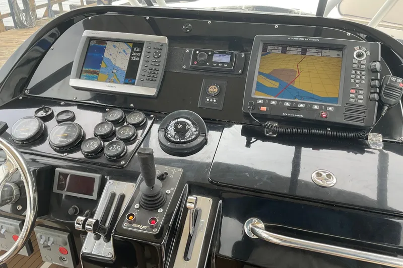 Slide: The Image of Control panel of a 2004 Rivolta PT Runner 4.0 boat with navigation screens and gauges. - 11