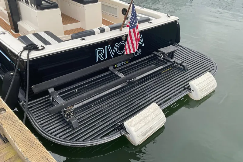 Slide: The Image of 2004 Rivolta PT Runner 4.0 boat with swim platform and American flag. - 18