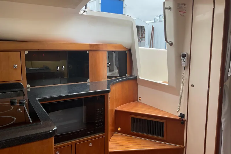 Slide: The Image of Interior of 2004 Rivolta PT Runner 4.0 yacht with wooden cabinetry and modern appliances. - 19