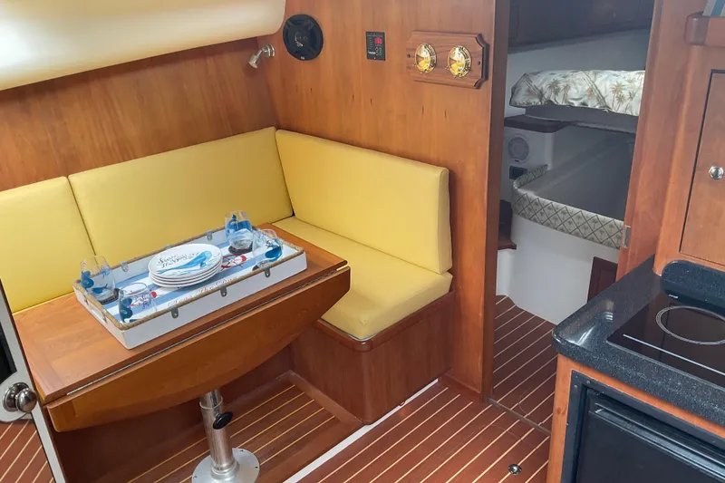Slide: The Image of Interior of 2004 Rivolta PT Runner 4.0 yacht with cozy seating and dining area. - 21