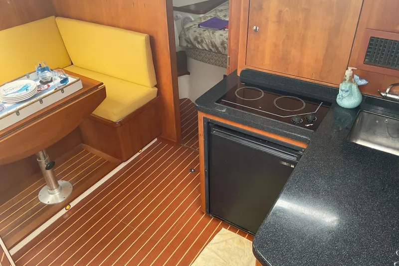 Slide: The Image of Interior of 2004 Rivolta PT Runner 4.0 yacht with kitchenette and seating area. - 23