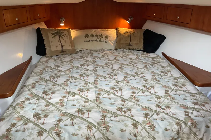 Slide: The Image of Cozy cabin interior of 2004 Rivolta PT Runner 4.0 with palm-themed bedding. - 24