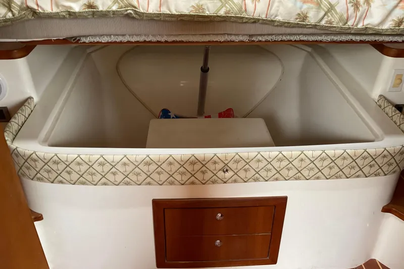 Slide: The Image of 2004 Rivolta PT Runner 4.0 interior storage compartment with patterned trim and wooden drawers. - 26