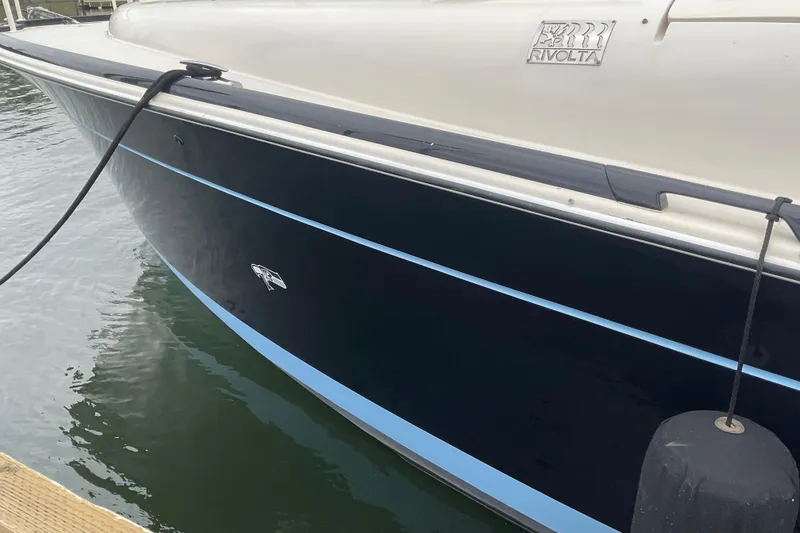 Slide: The Image of 2004 Rivolta PT Runner 4.0 boat docked, showcasing sleek design and branding. - 5