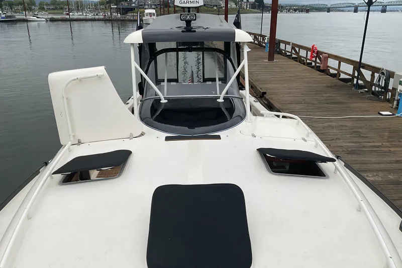 Slide: The Image of 2004 Rivolta PT Runner 4.0 docked at a marina, showcasing sleek design and modern features. - 8