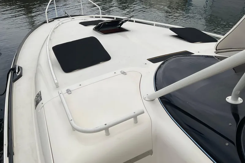 Slide: The Image of 2004 Rivolta PT Runner 4.0 boat deck with sleek design and water reflections. - 9