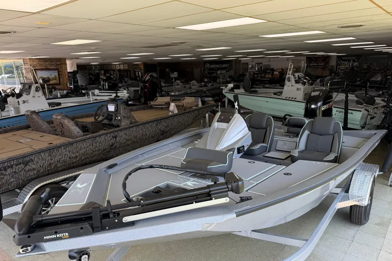 The Image of 2026 Xpress H17 boat displayed in a showroom with various other boats. - 0
