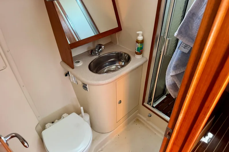 Slide: The Image of 2007 Hunter 41 Deck Salon bathroom with sink, mirror, and shower. - 12