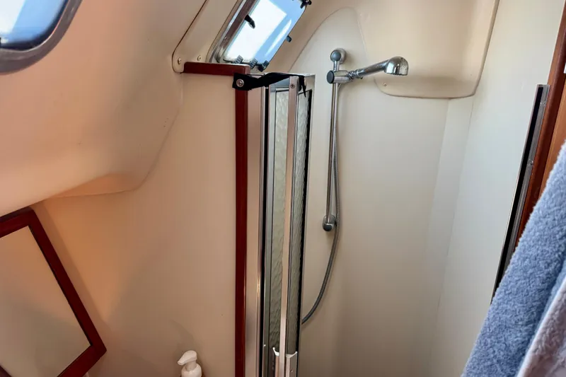 Slide: The Image of Shower area in 2007 Hunter 41 Deck Salon yacht, featuring a handheld showerhead and compact design. - 13