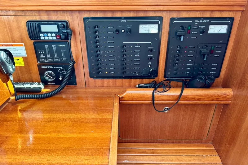 Slide: The Image of Control panel of a 2007 Hunter 41 Deck Salon sailboat, featuring navigation and communication equipment. - 16