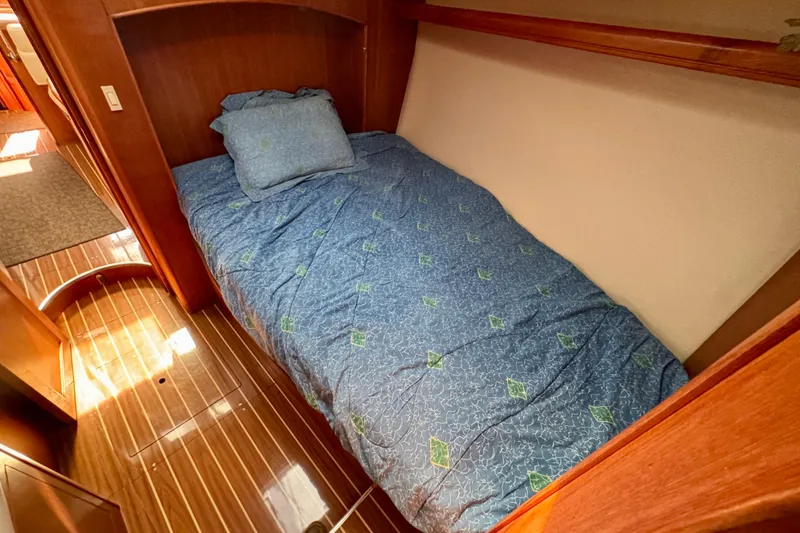 Slide: The Image of Cozy cabin bed in 2007 Hunter 41 Deck Salon yacht with blue bedding. - 21