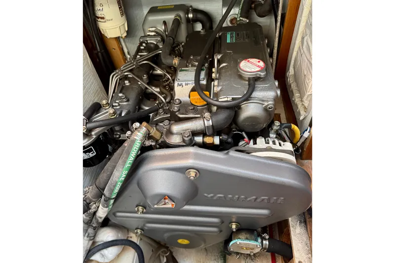 Slide: The Image of Engine compartment of a 2007 Hunter 41 Deck Salon sailboat, featuring a Yanmar engine. - 24