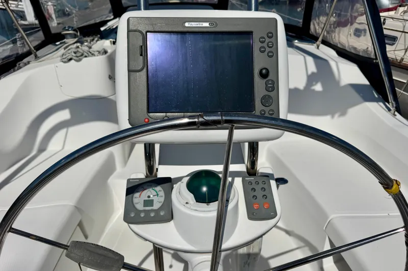 Slide: The Image of Steering console of 2007 Hunter 41 Deck Salon sailboat with navigation equipment. - 25