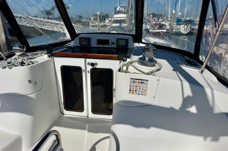 Slide: The Image of Cockpit of 2007 Hunter 41 Deck Salon sailboat with navigation equipment and marina view. - 26