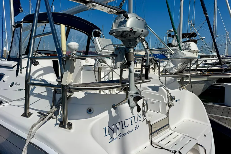 Slide: The Image of 2007 Hunter 41 Deck Salon yacht docked, featuring "Invictus" name and Honda motor. - 27