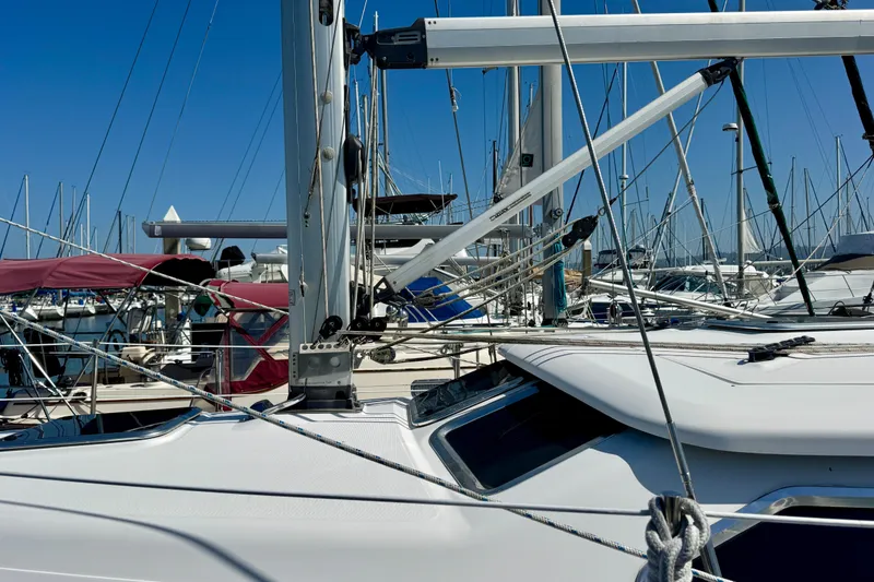 Slide: The Image of 2007 Hunter 41 Deck Salon sailboat in marina, surrounded by other vessels under clear blue sky. - 28