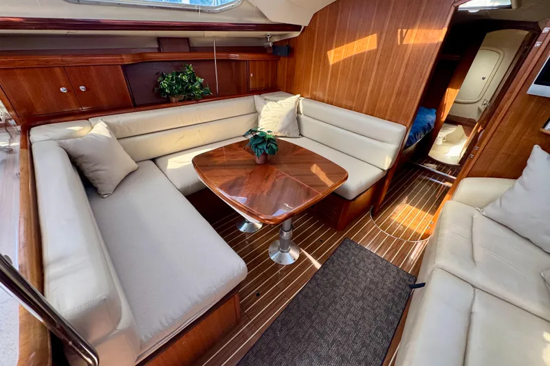Slide: The Image of Luxurious interior of 2007 Hunter 41 Deck Salon with elegant wood finish and plush seating. - 3