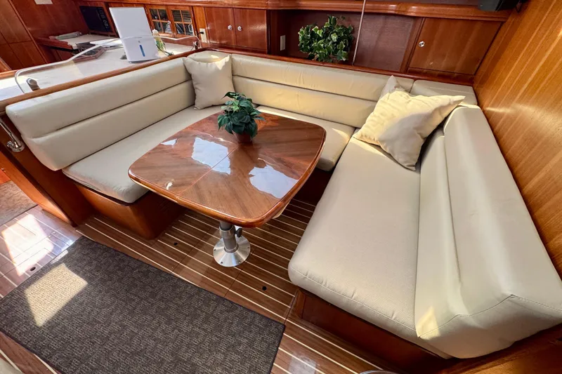 Slide: The Image of Luxurious interior of 2007 Hunter 41 Deck Salon with elegant seating and wooden table. - 5