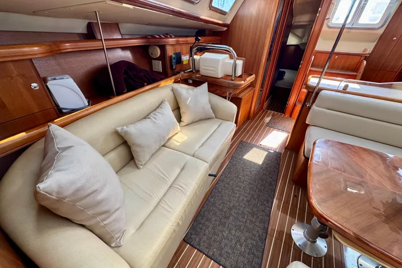 Slide: The Image of Luxurious interior of 2007 Hunter 41 Deck Salon yacht with plush seating and wooden finishes. - 6