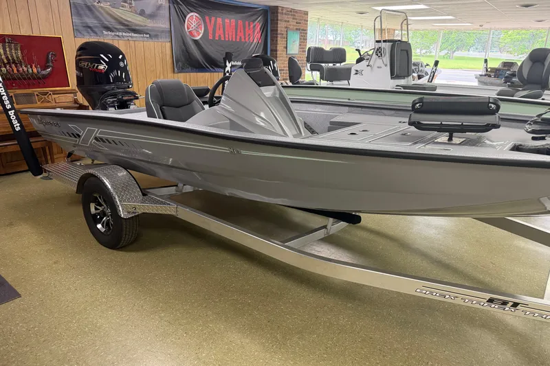 Slide: The Image of 2026 Xpress H18C Crappie boat displayed indoors on a trailer. - 3