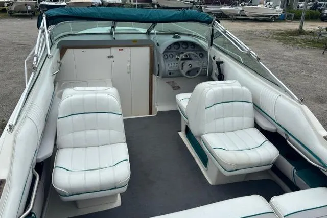 Slide: The Image of 1994 Sea Ray 240 boat interior with white seating and dashboard view. - 10