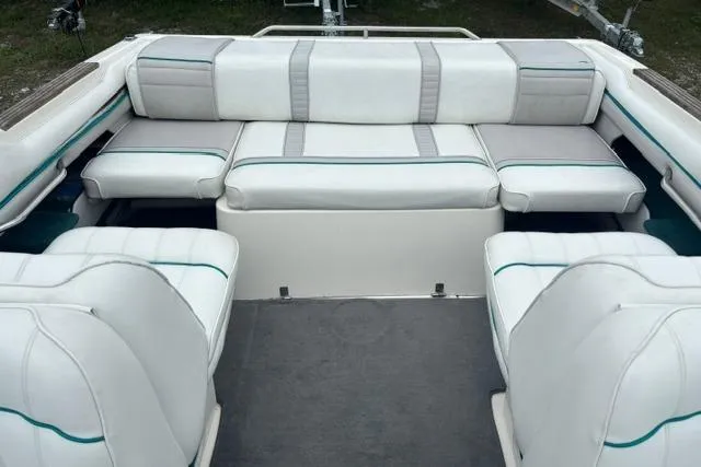 Slide: The Image of 1994 Sea Ray 240 boat interior with white cushioned seating and gray accents. - 11