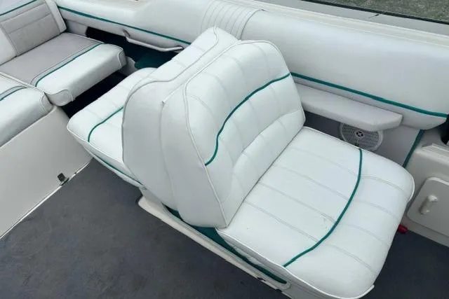 Slide: The Image of White leather seating on a 1994 Sea Ray 240 boat with green accents. - 12