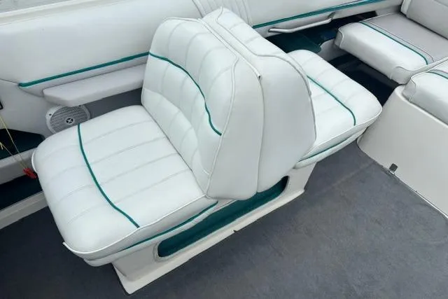 Slide: The Image of White leather seats on a 1994 Sea Ray 240 boat, featuring green accents. - 13
