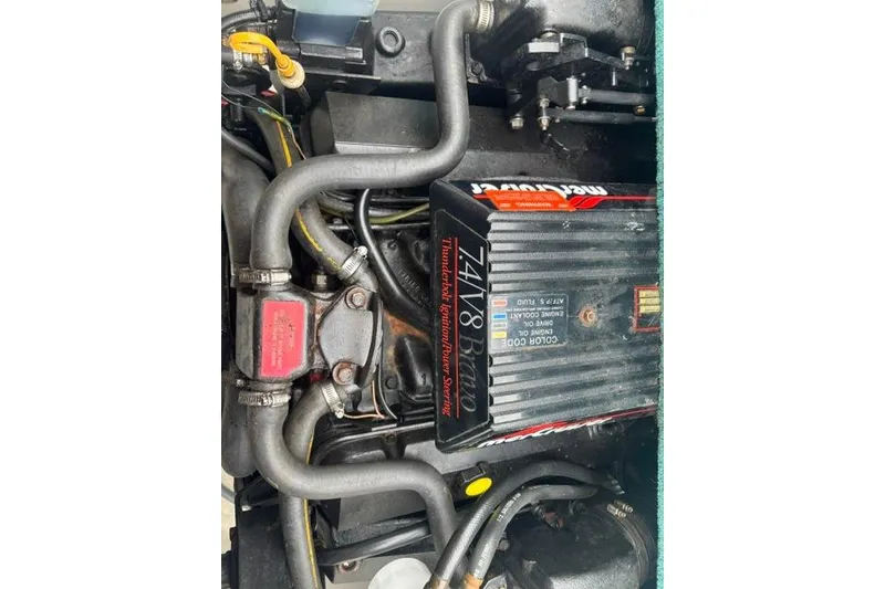 Slide: The Image of Engine of a 1994 Sea Ray 240 boat, featuring MerCruiser components. - 23