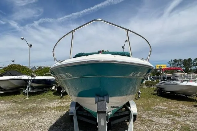 Slide: The Image of 1994 Sea Ray 240 boat on trailer under clear sky. - 8