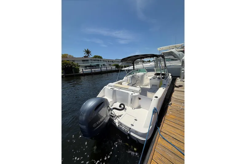 Slide: The Image of 2015 Robalo R227 Dual Console boat docked with Yamaha outboard motor. - 11