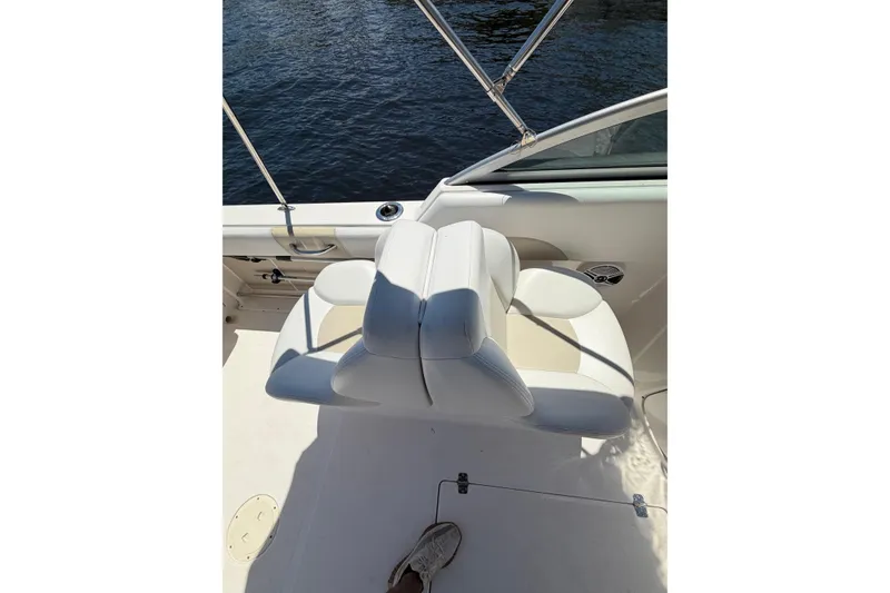 Slide: The Image of 2015 Robalo R227 Dual Console boat interior with white seating and water view. - 12
