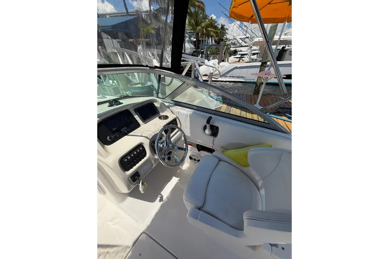 Slide: The Image of 2015 Robalo R227 Dual Console boat interior with steering wheel and dashboard controls. - 13