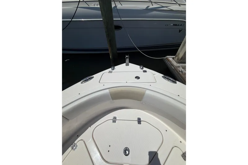 Slide: The Image of 2015 Robalo R227 Dual Console boat bow view at dock. - 20