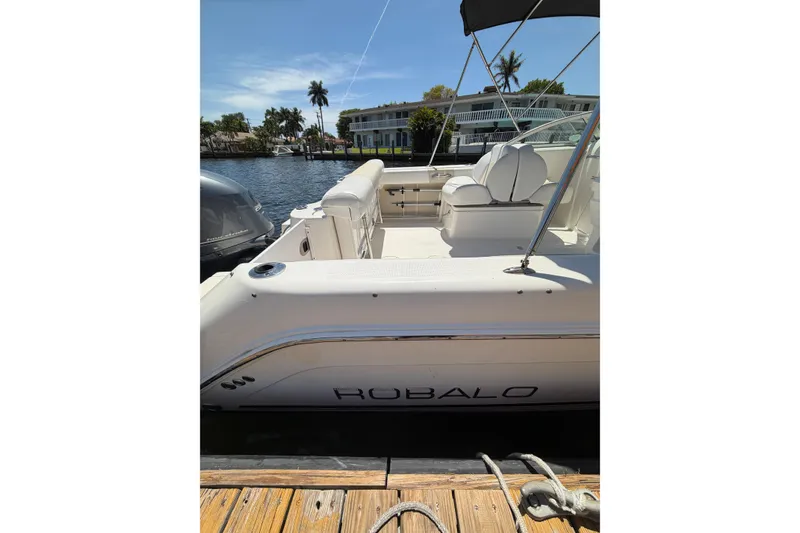 Slide: The Image of 2015 Robalo R227 Dual Console boat docked by waterfront homes. - 22
