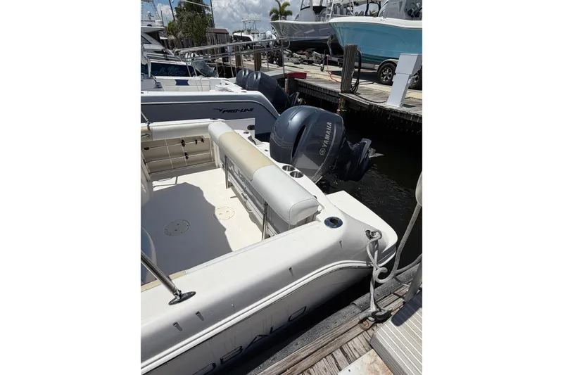 Slide: The Image of 2015 Robalo R227 Dual Console boat docked with Yamaha outboard engine. - 23