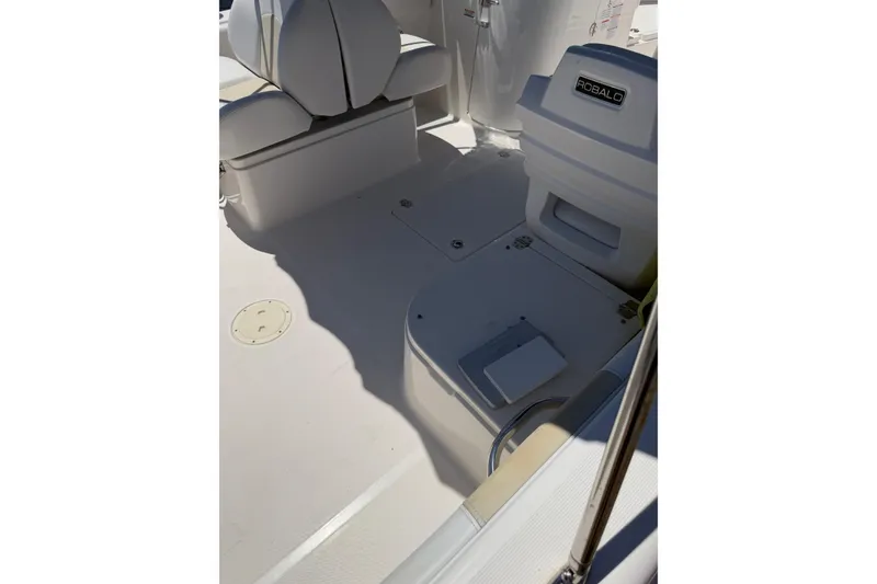 Slide: The Image of 2015 Robalo R227 Dual Console boat interior with seating and storage compartments. - 25