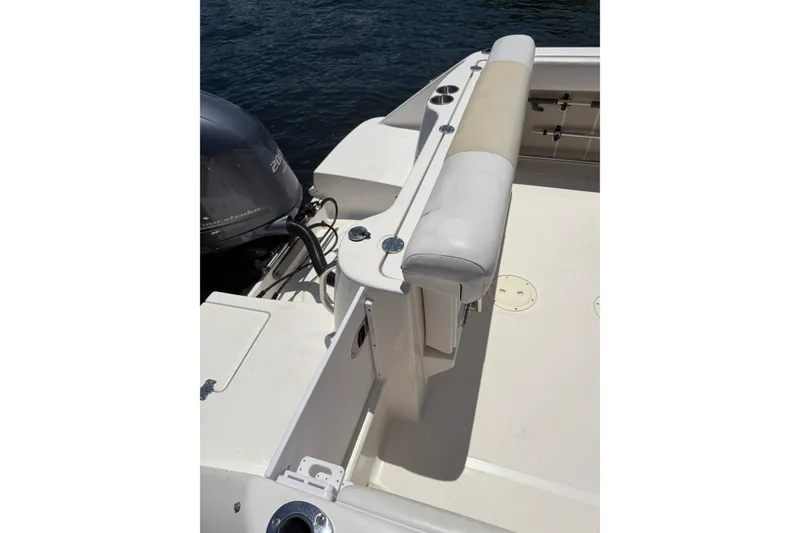 Slide: The Image of 2015 Robalo R227 Dual Console boat with cushioned seating and outboard motor. - 26