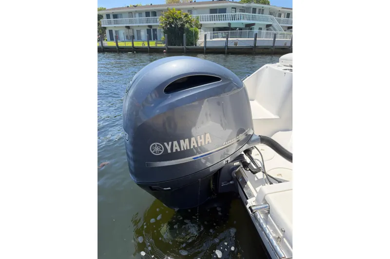 Slide: The Image of Yamaha outboard motor on 2015 Robalo R227 Dual Console boat, docked by waterfront property. - 27