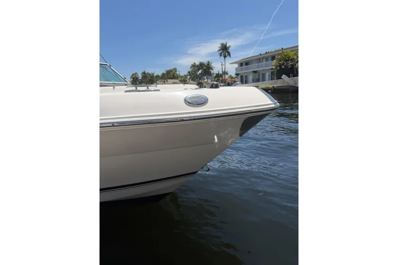 Slide: The Image of 2015 Robalo R227 Dual Console boat docked on a sunny waterfront. - 29