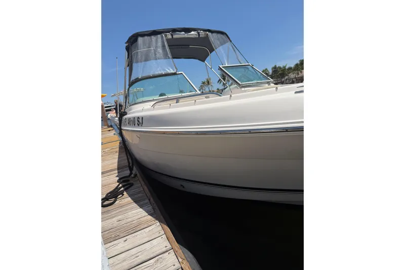 Slide: The Image of 2015 Robalo R227 Dual Console boat docked under clear blue sky. - 30