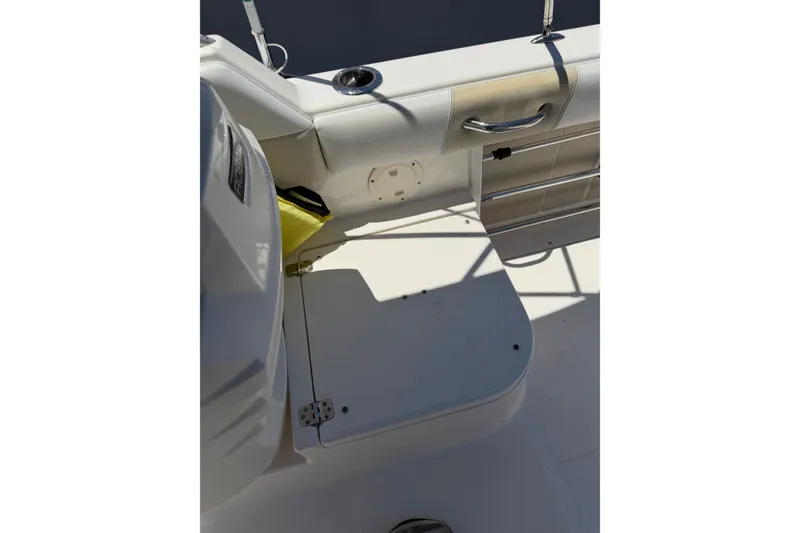Slide: The Image of 2015 Robalo R227 Dual Console boat interior, featuring seating and storage compartments. - 34