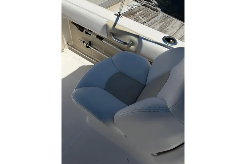 Slide: The Image of 2015 Robalo R227 Dual Console boat seat with dock view. - 35