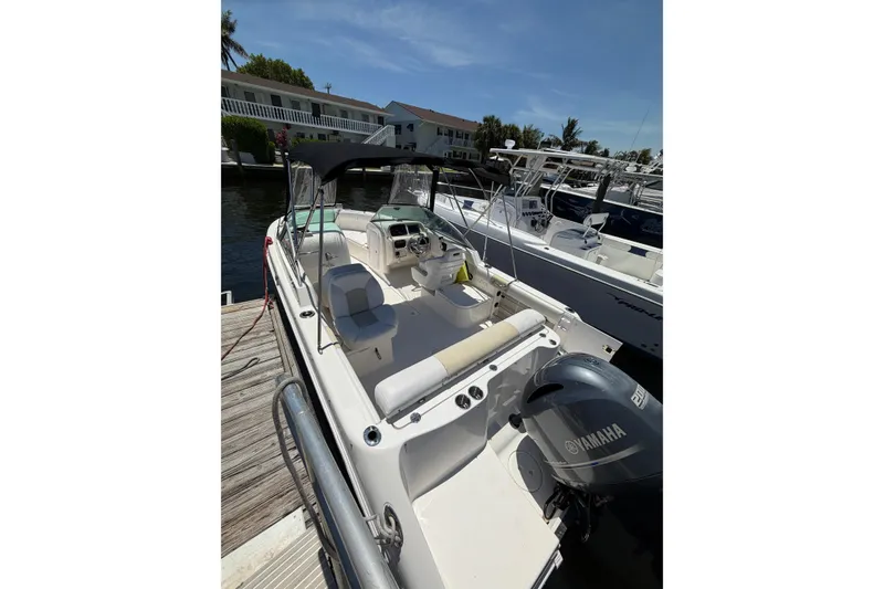 Slide: The Image of 2015 Robalo R227 Dual Console boat docked with Yamaha engine. - 5