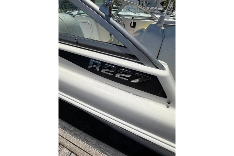 Slide: The Image of 2015 Robalo R227 Dual Console boat, side view with model emblem. - 6