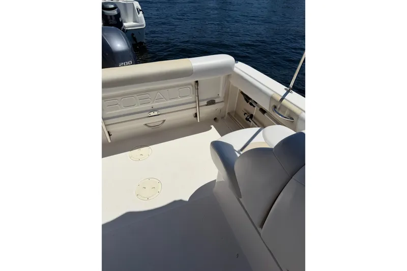 Slide: The Image of 2015 Robalo R227 Dual Console boat interior with seating and outboard motor. - 8